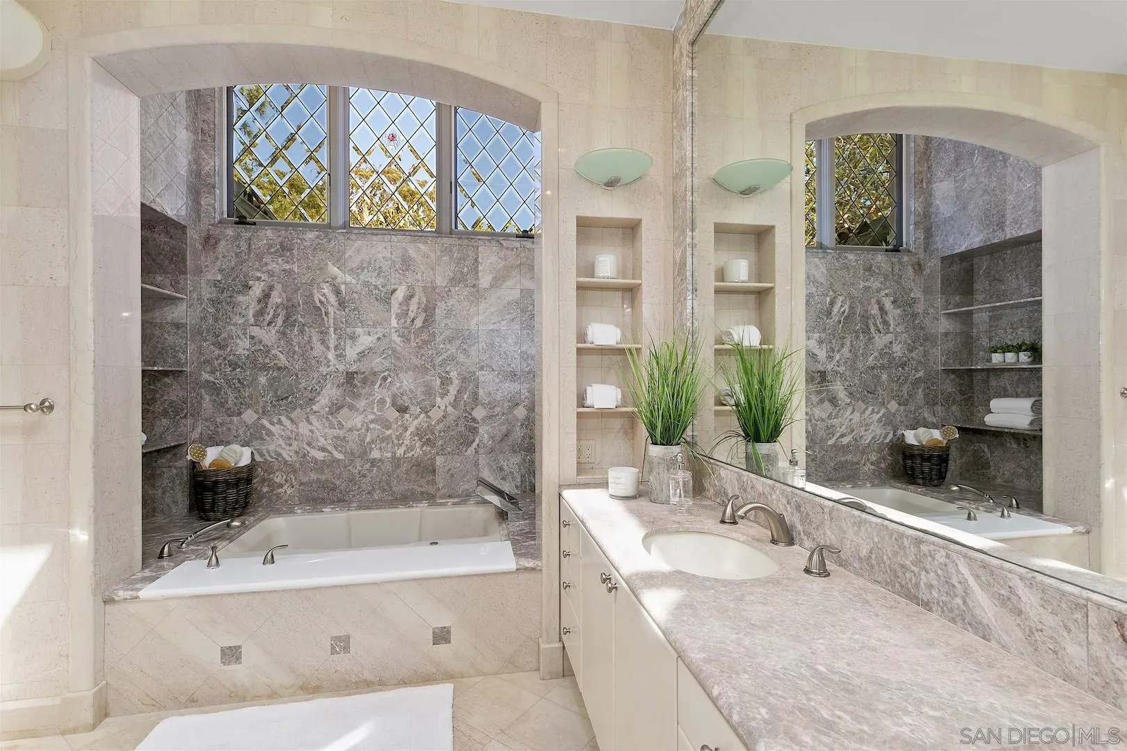 9660 Blackgold Road La Jolla, CA 92037 - Photo 25 of 32 a bathroom with a granite countertop sink a mirror a bathtub and shower