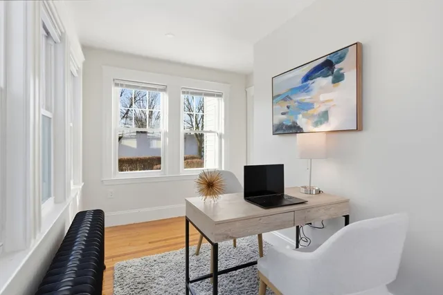 a view of an empty room with wooden floor