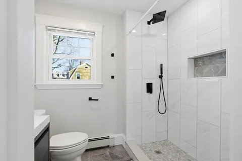 a bathroom with a bathtub and a toilet