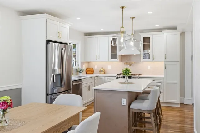 a view of a hallway with wooden floor and dining room