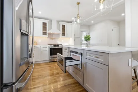 a kitchen with kitchen island granite countertop lots of counter top space and appliances