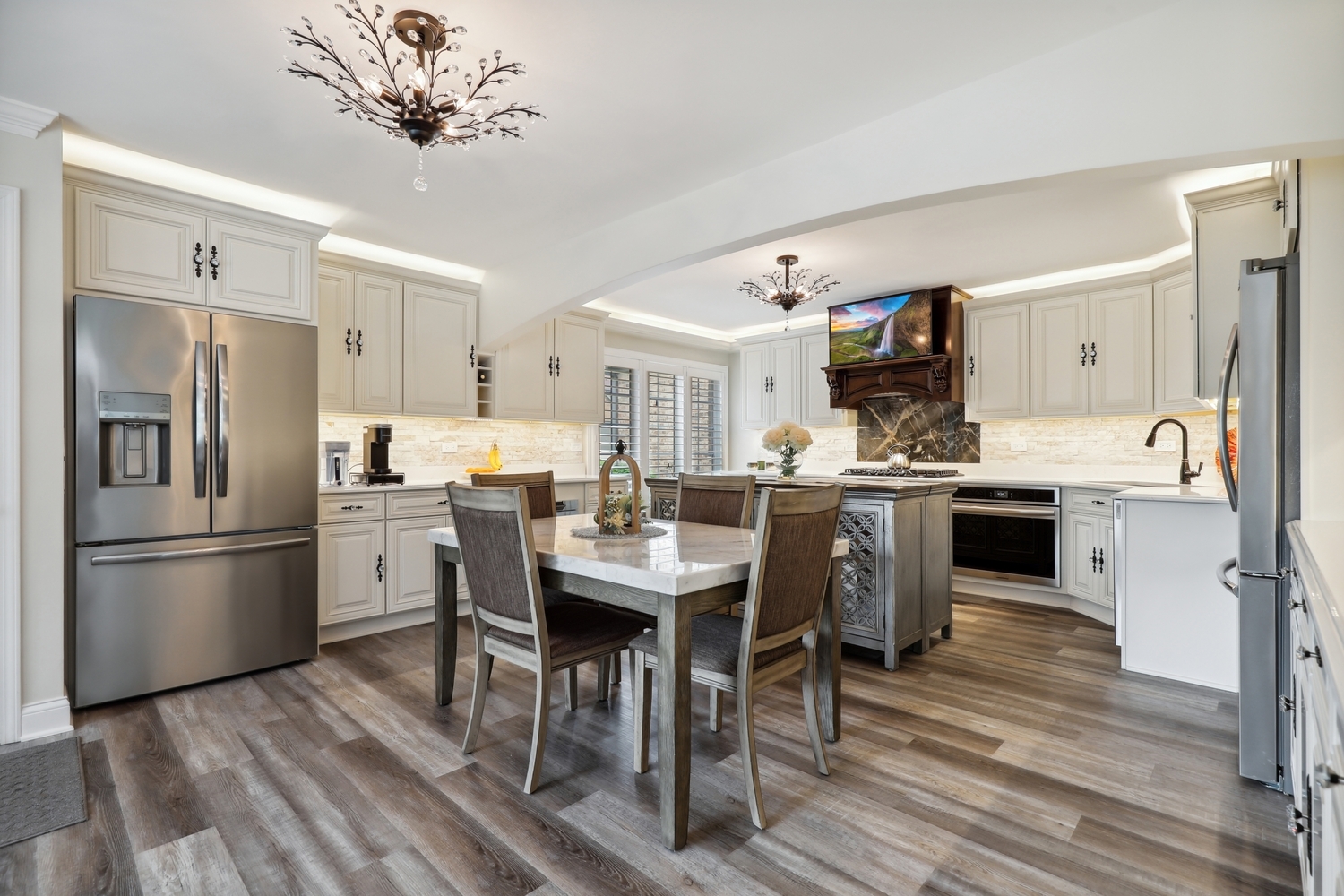 10508 Golf Road Orland Park, IL 60462 - Photo 15 of 50 a kitchen with stainless steel appliances a stove a refrigerator and a fireplace