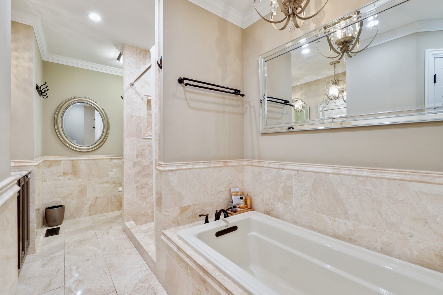 10508 Golf Road Orland Park, IL 60462 - Photo 24 of 50 a bathroom with a bathtub a sink and a mirror