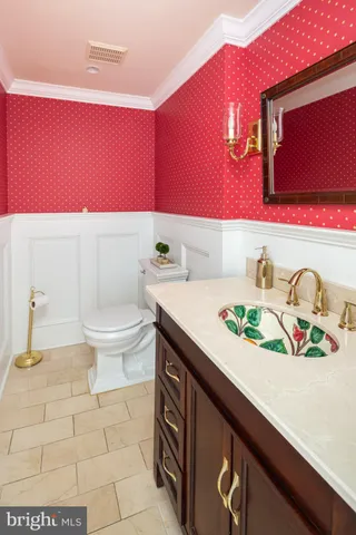 a bathroom with a sink a toilet and mirror