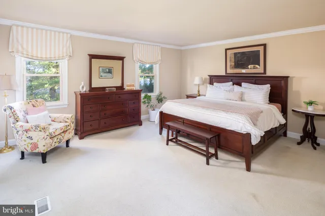 a spacious bedroom with a bed and window