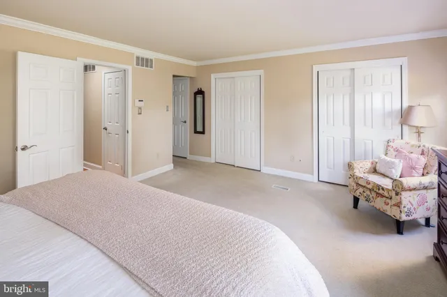 a bedroom with a bed and a couch