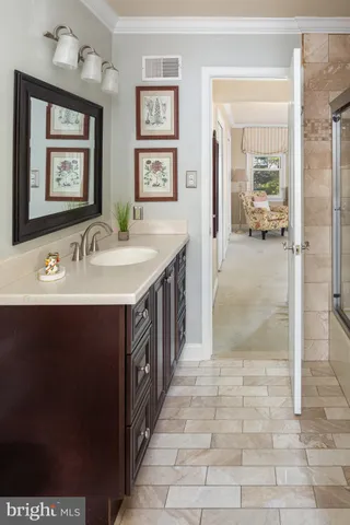 a en suite bathroom with a sink and a mirror
