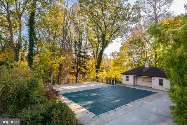 a view of a house with large trees