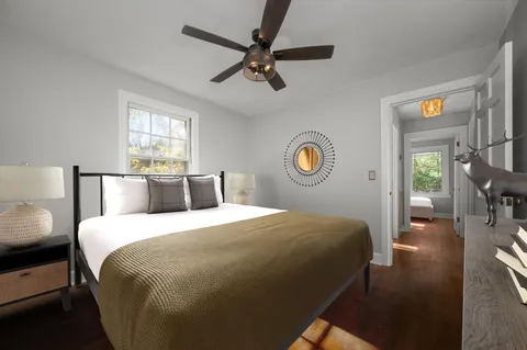 a bedroom with a bed and a chandelier