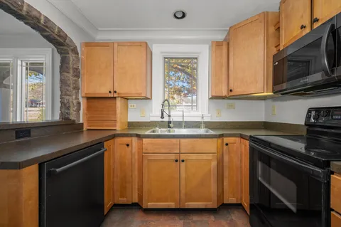 a kitchen with stainless steel appliances granite countertop a sink stove and microwave