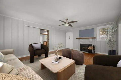 a living room with furniture fireplace and a window