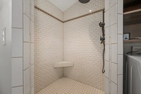 a bathroom with a toilet and a shower