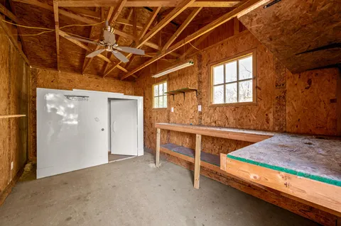 a storage room with water heater and wooden cabinets