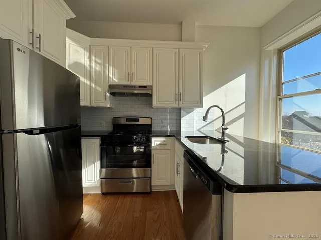 a kitchen with stainless steel appliances a refrigerator and a sink