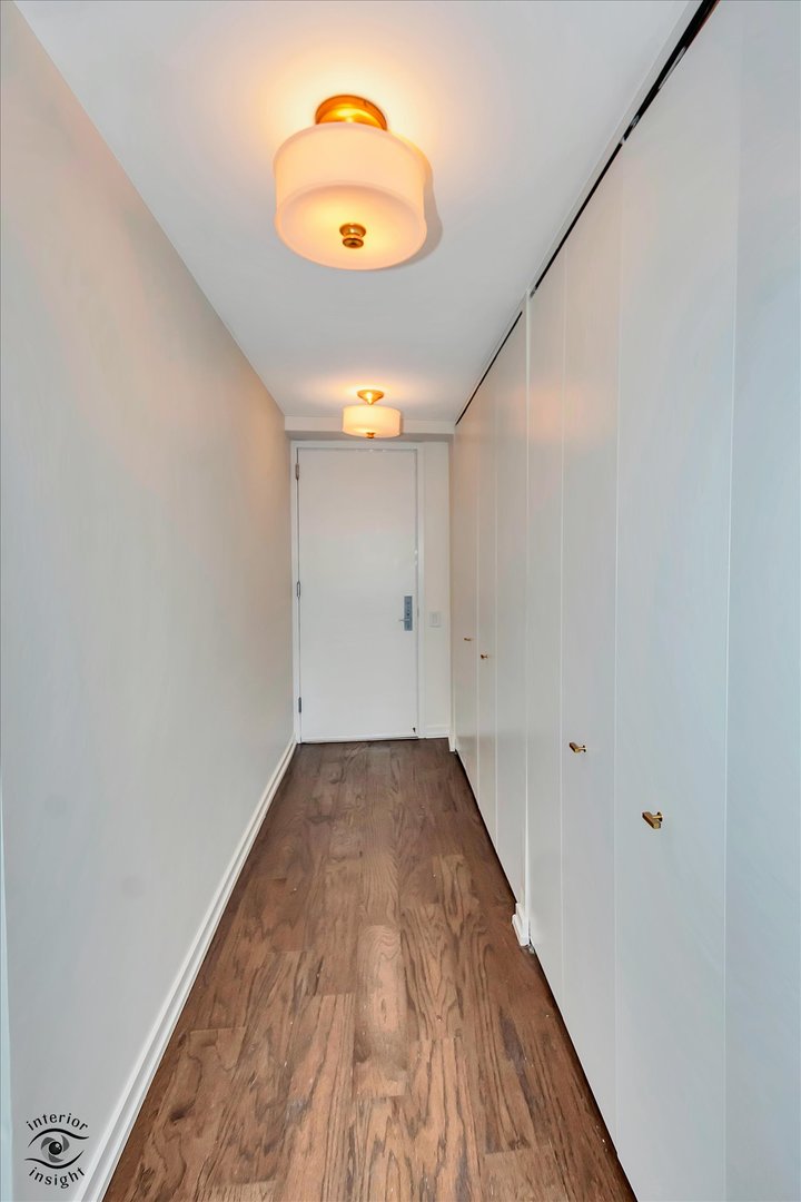 200 East Delaware Place, Unit 26E Chicago, IL 60611 - Photo 15 of 28 an empty room with wooden floor