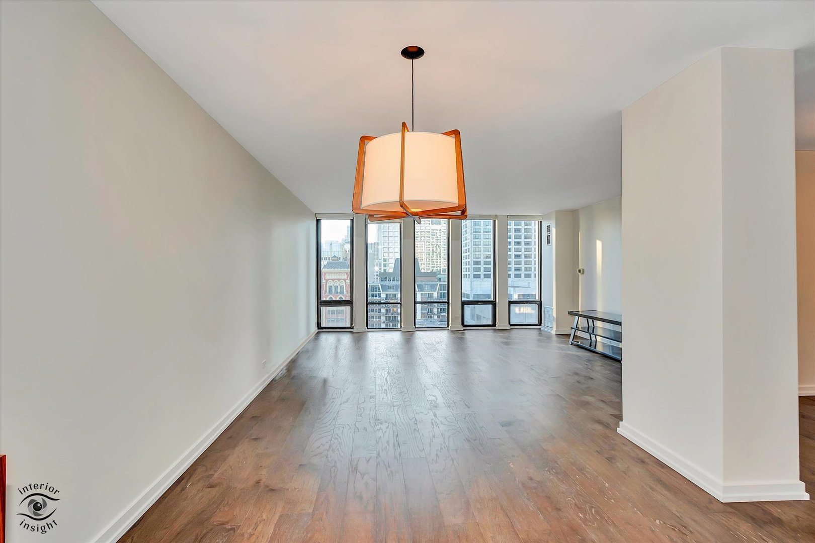 200 East Delaware Place, Unit 26E Chicago, IL 60611 - Photo 8 of 28 a view of an empty room with wooden floor and a window