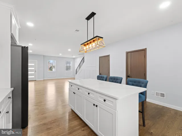 a kitchen with white cabinets and appliances