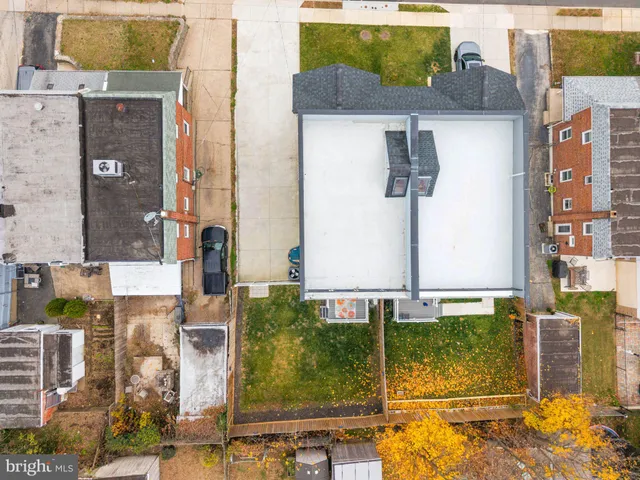 aerial view of a house with street