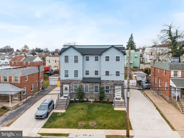 aerial view of a house with street