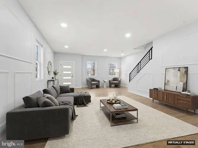 a living room with furniture rug and a window
