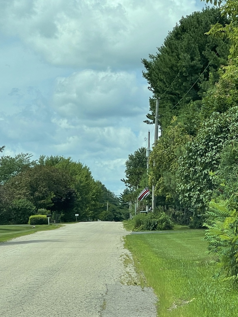 8702 Regnier Road Hebron, IL 60034 - Photo 8 of 19 a view of a field with plants and trees in the background