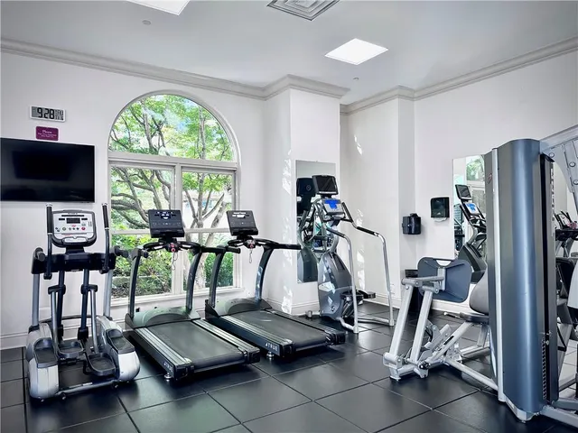 a room with gym equipment and a large window