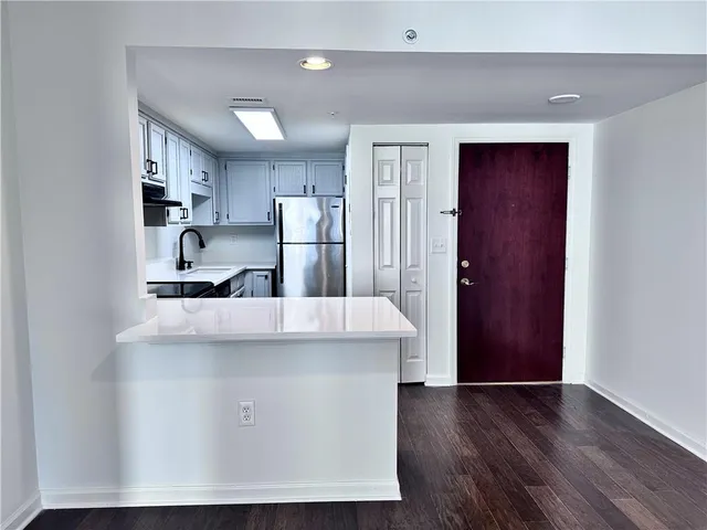 a view of kitchen with stainless steel appliances a refrigerator and a stove top oven