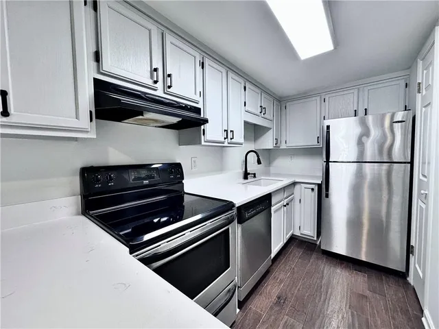 a kitchen with stainless steel appliances a refrigerator stove and microwave