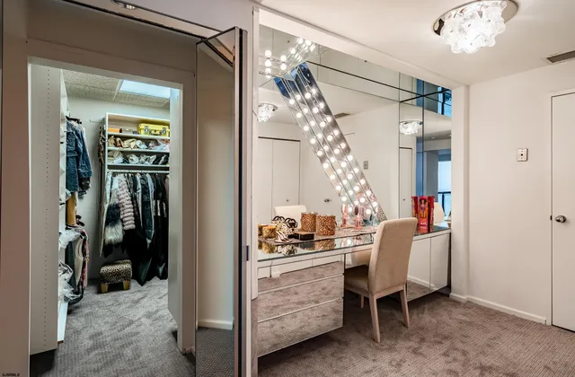 a view of a bedroom with furniture and workspace