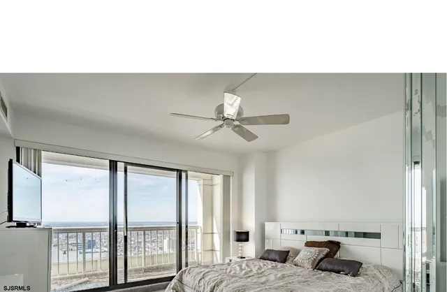 a living room with furniture and a ceiling fan
