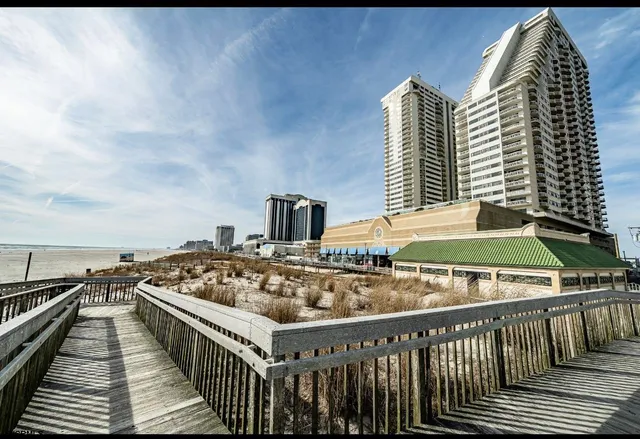 a roof deck with a barbeque and wooden floor