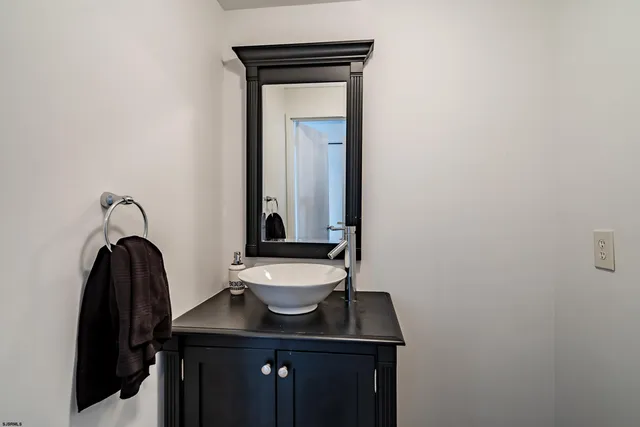a bathroom with a sink a mirror and a toilet