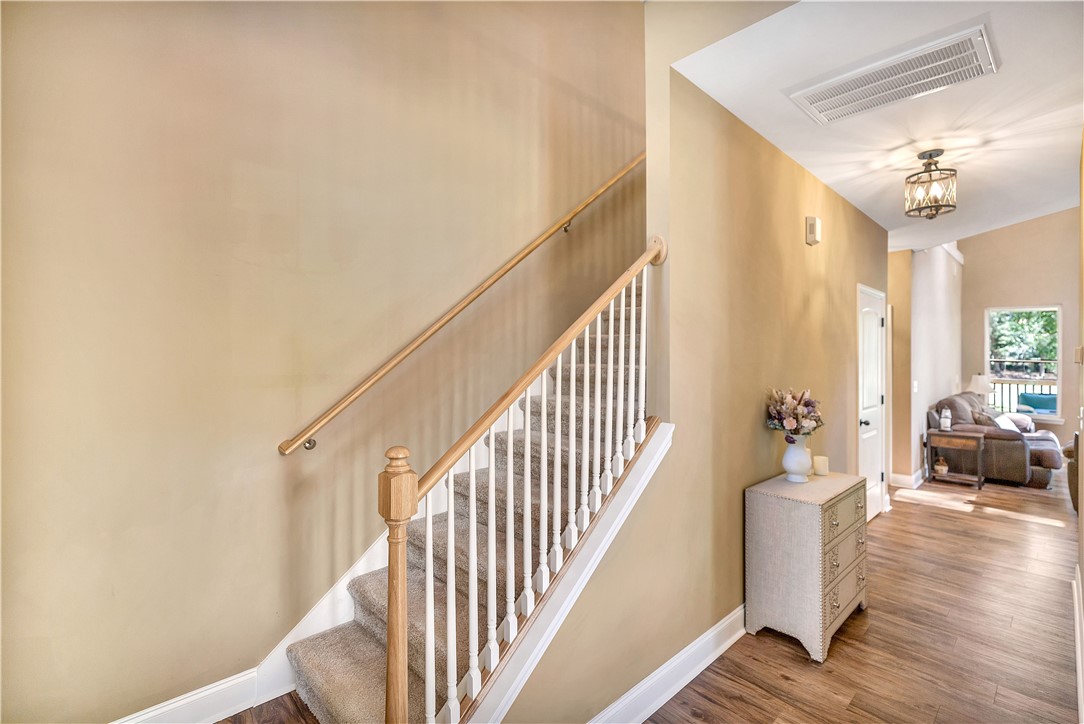 3004 Cobbs Way Anderson, SC 29621 - Photo 3 of 46 A classic wooden staircase leads upward from the warm hardwood-floored entry hall.