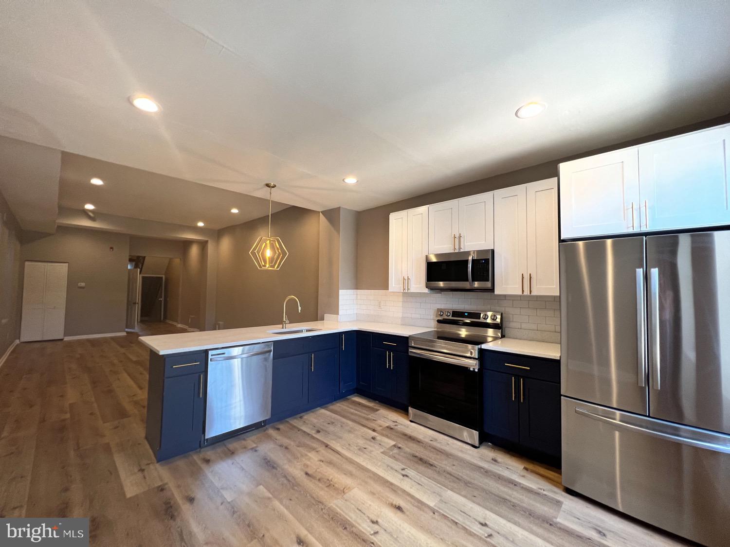 a kitchen with stainless steel appliances granite countertop a refrigerator and a sink