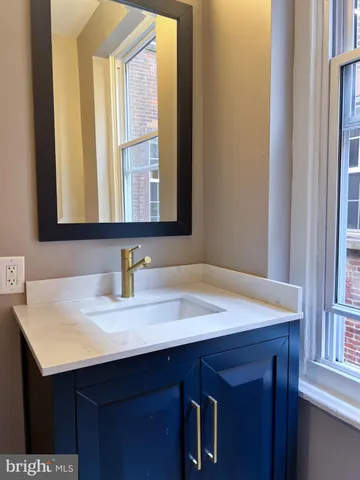 a bathroom with a sink vanity and a mirror