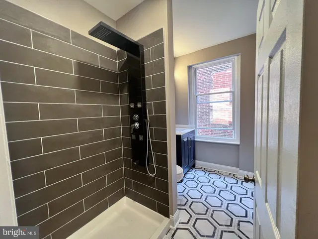 a bathroom with a window and a shower
