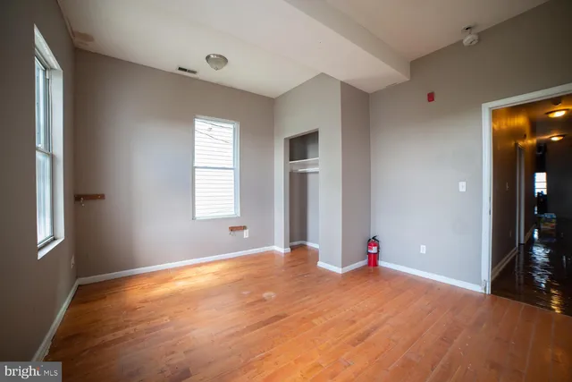 a view of a livingroom with wooden floor and window