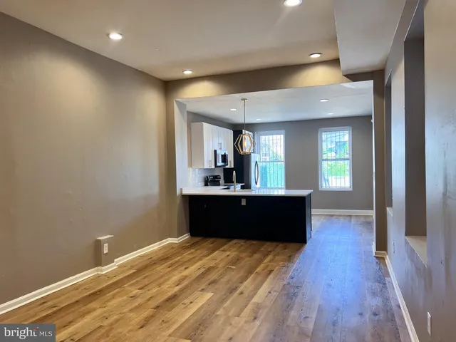 a living room with a couch and wooden floor