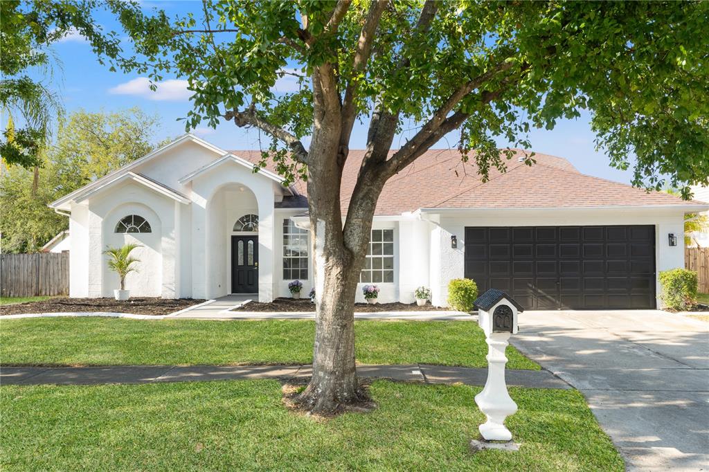 1608 Ledgestone Drive Brandon, FL 33511 - Photo 1 of 1 a front view of a house with a yard and garage