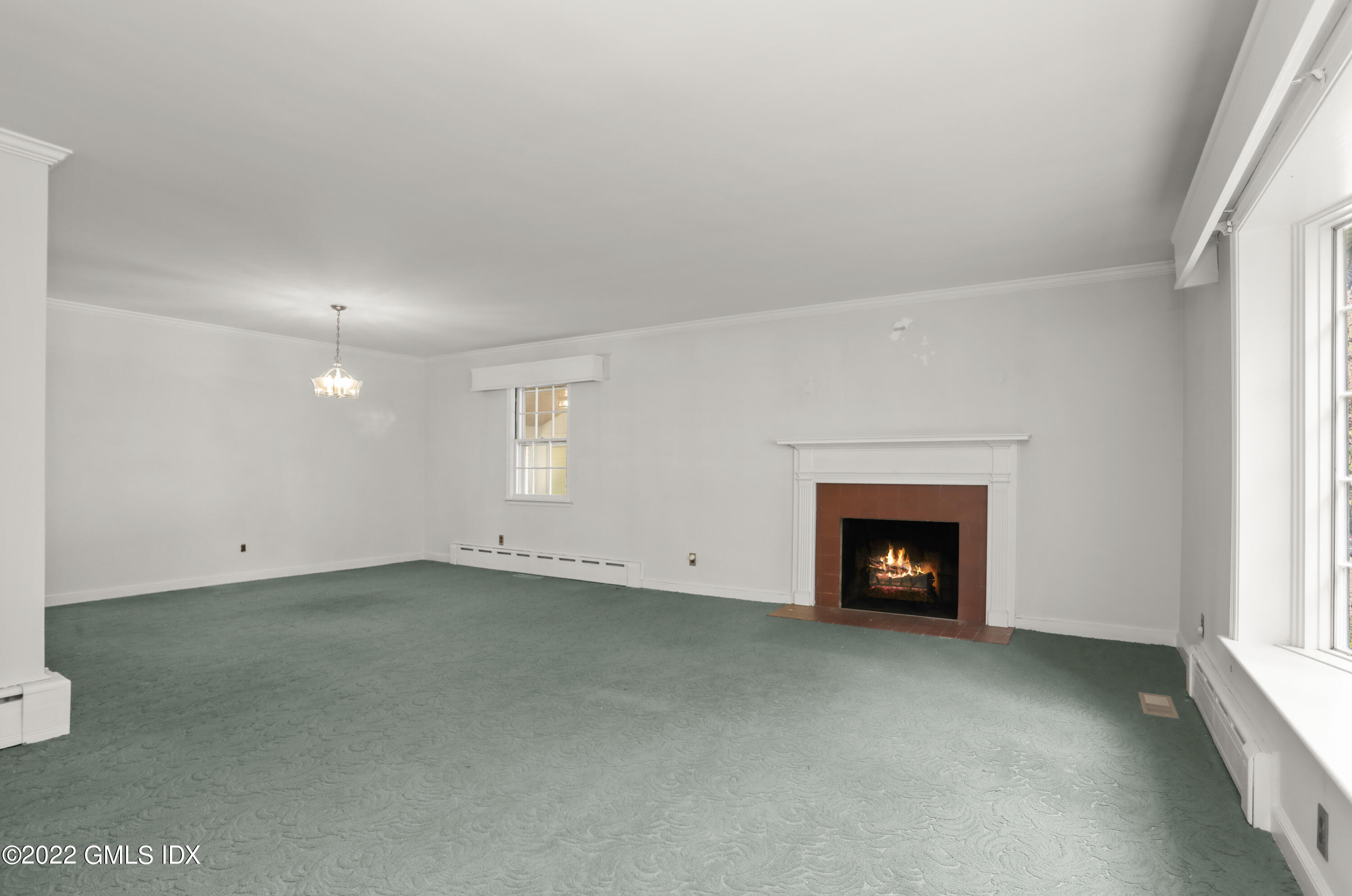 5 Skylark Road Greenwich, CT 06830 - Photo 4 of 21 an empty room with a fireplace and window