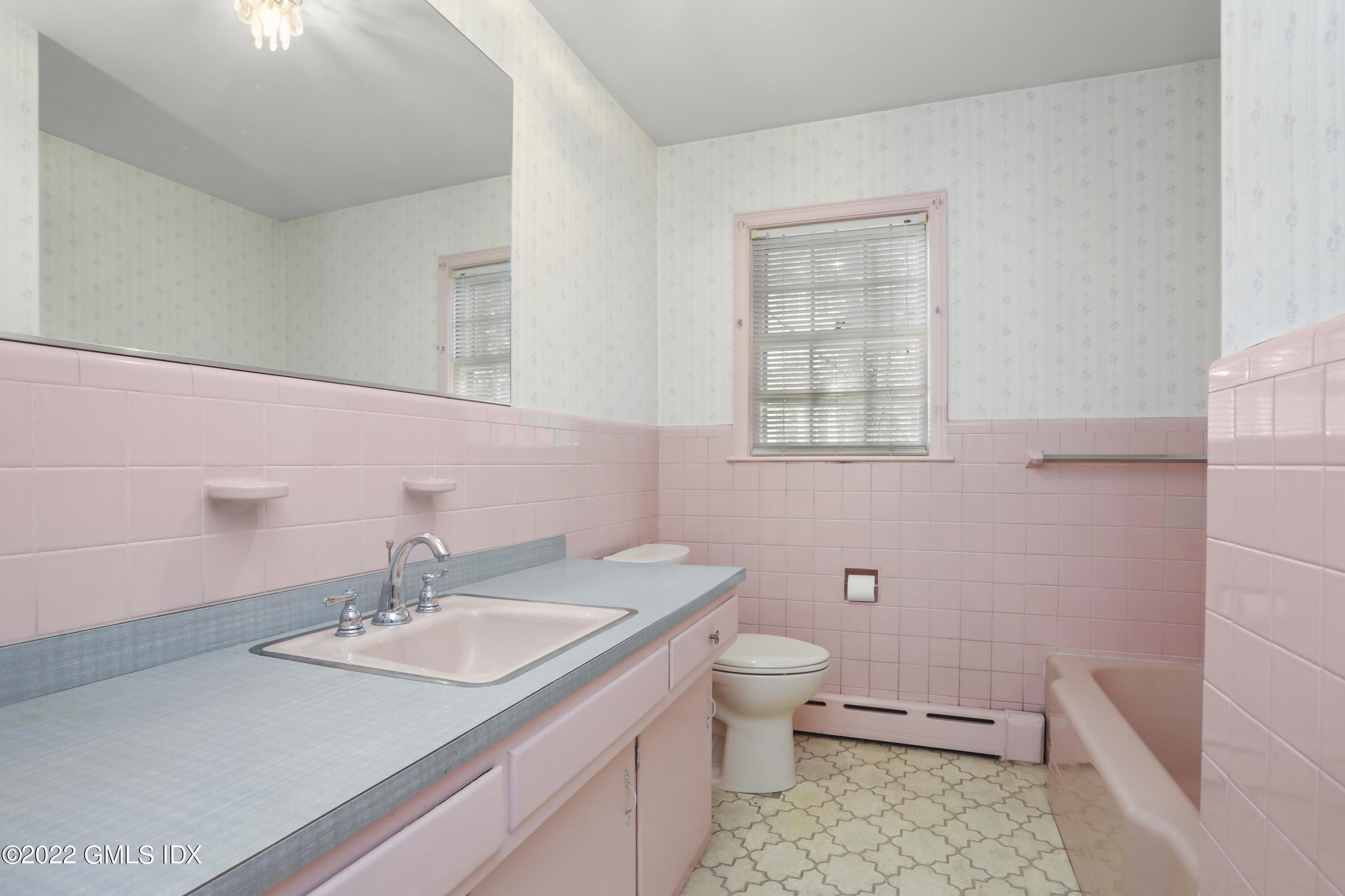 5 Skylark Road Greenwich, CT 06830 - Photo 8 of 21 a bathroom with a granite countertop toilet a sink and a mirror