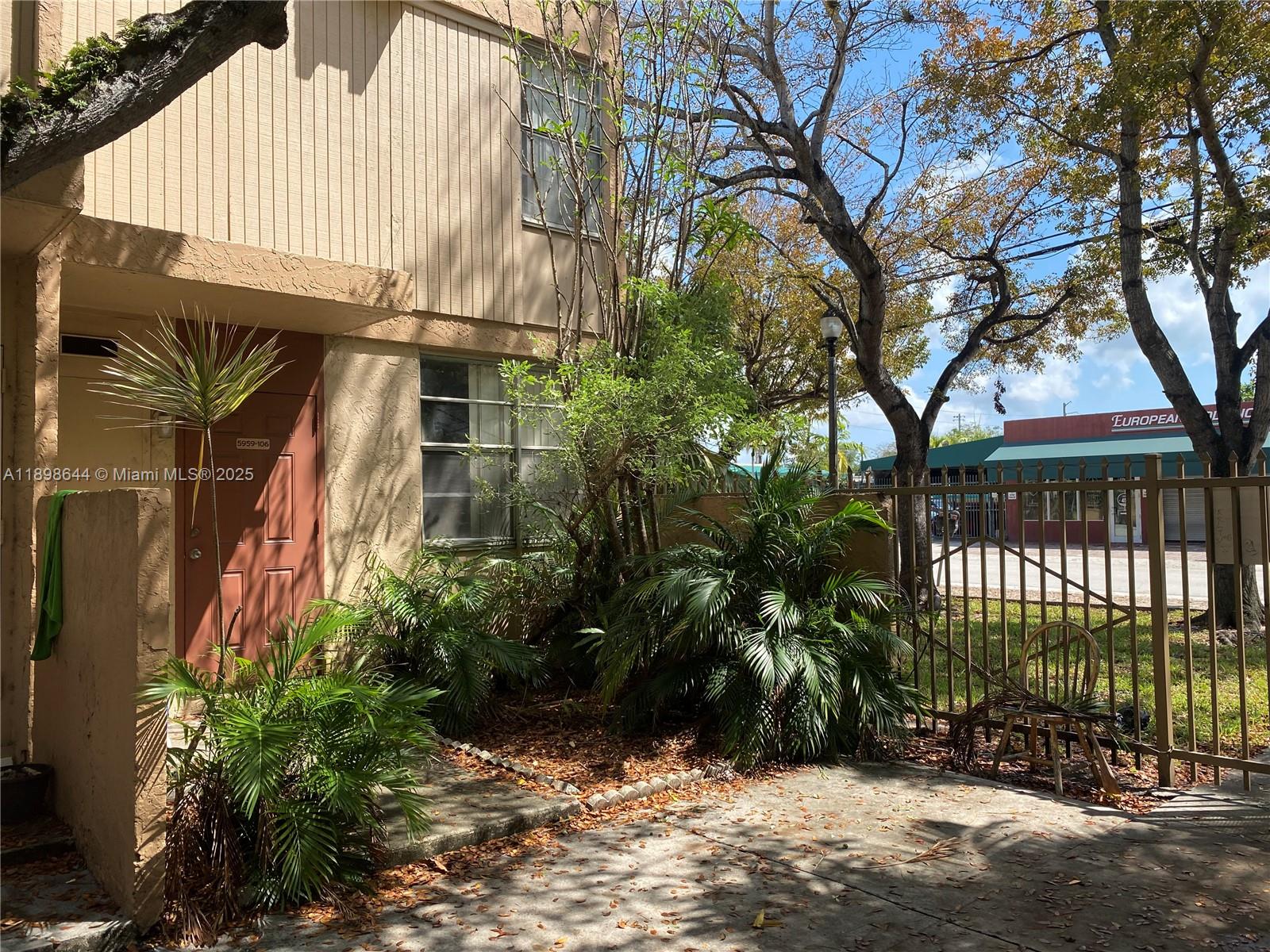 5959 Southwest 69th Street, Unit 106 Miami, FL 33143 - Photo 1 of 17 a view of a house with a yard