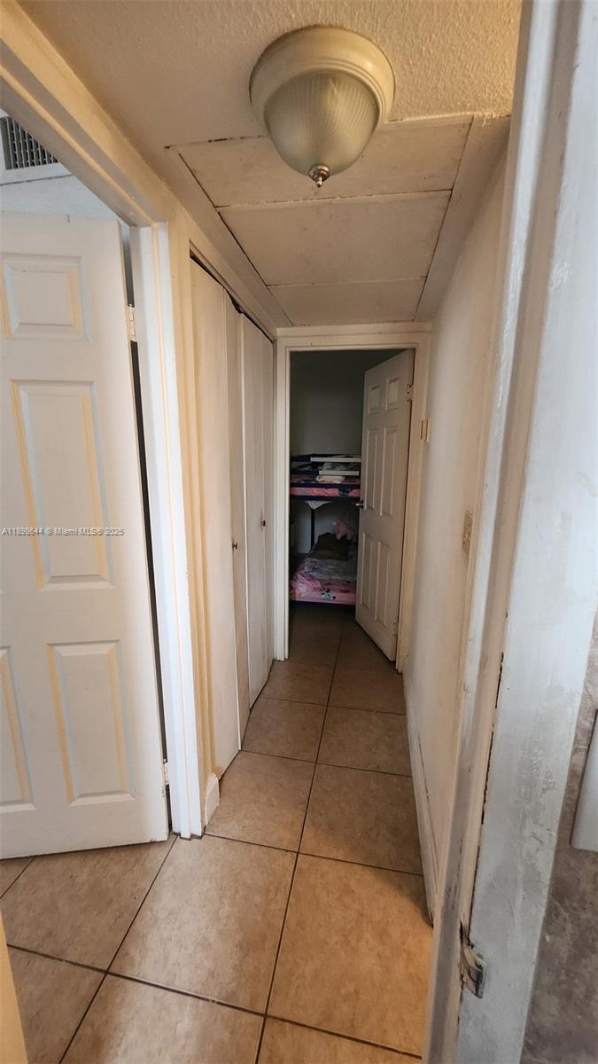 5959 Southwest 69th Street, Unit 106 Miami, FL 33143 - Photo 15 of 17 a view of a hallway to rooms