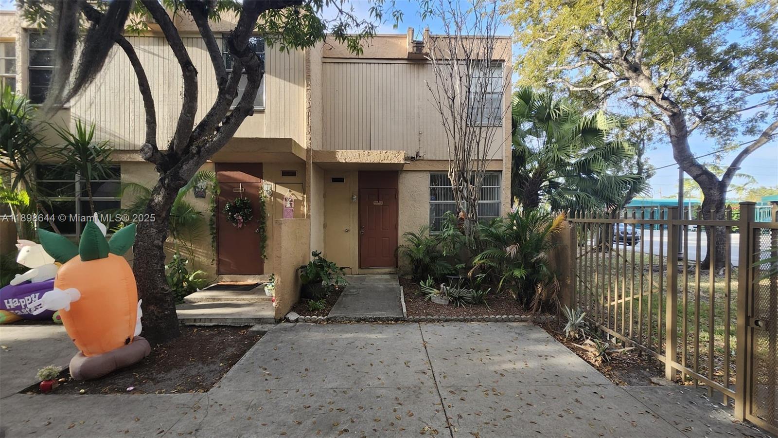 5959 Southwest 69th Street, Unit 106 Miami, FL 33143 - Photo 2 of 17 a view of a patio with table and chairs and potted plants