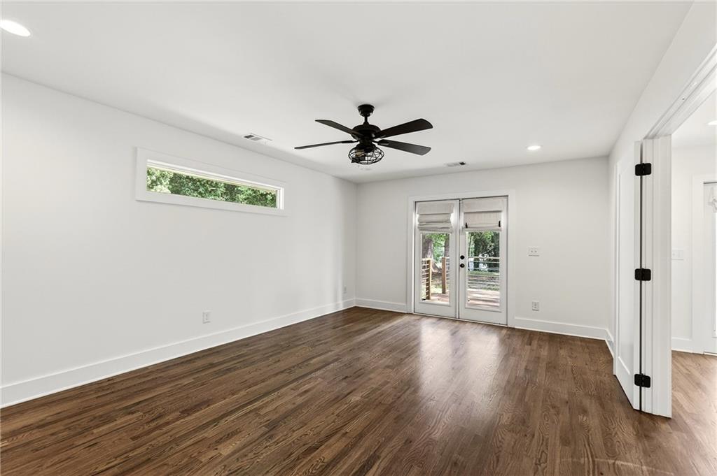 1344 Midlawn Drive Decatur, GA 30032 - Photo 51 of 87 a view of an empty room with wooden floor and a ceiling fan