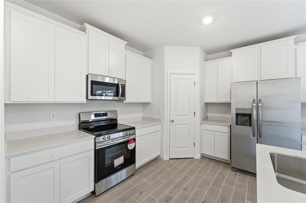 6680 Southwest 89th Loop Ocala, FL 34476 - Photo 13 of 39 a kitchen with cabinets and steel appliances
