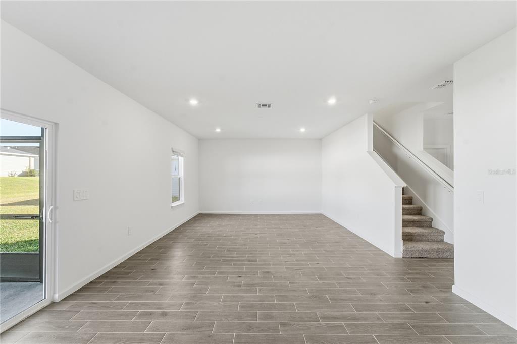 6680 Southwest 89th Loop Ocala, FL 34476 - Photo 17 of 39 wooden floor in an empty room with a window