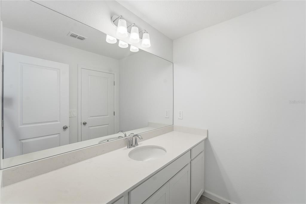 6680 Southwest 89th Loop Ocala, FL 34476 - Photo 25 of 39 a bathroom with a sink and a mirror