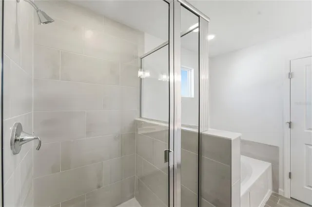 a bathroom with a glass shower door