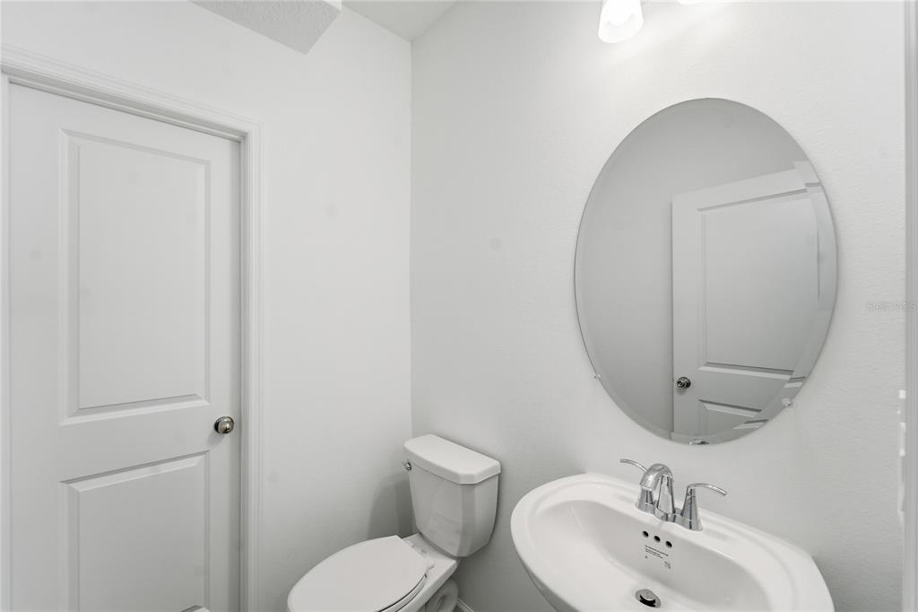 6680 Southwest 89th Loop Ocala, FL 34476 - Photo 32 of 39 a bathroom with a toilet sink and mirror